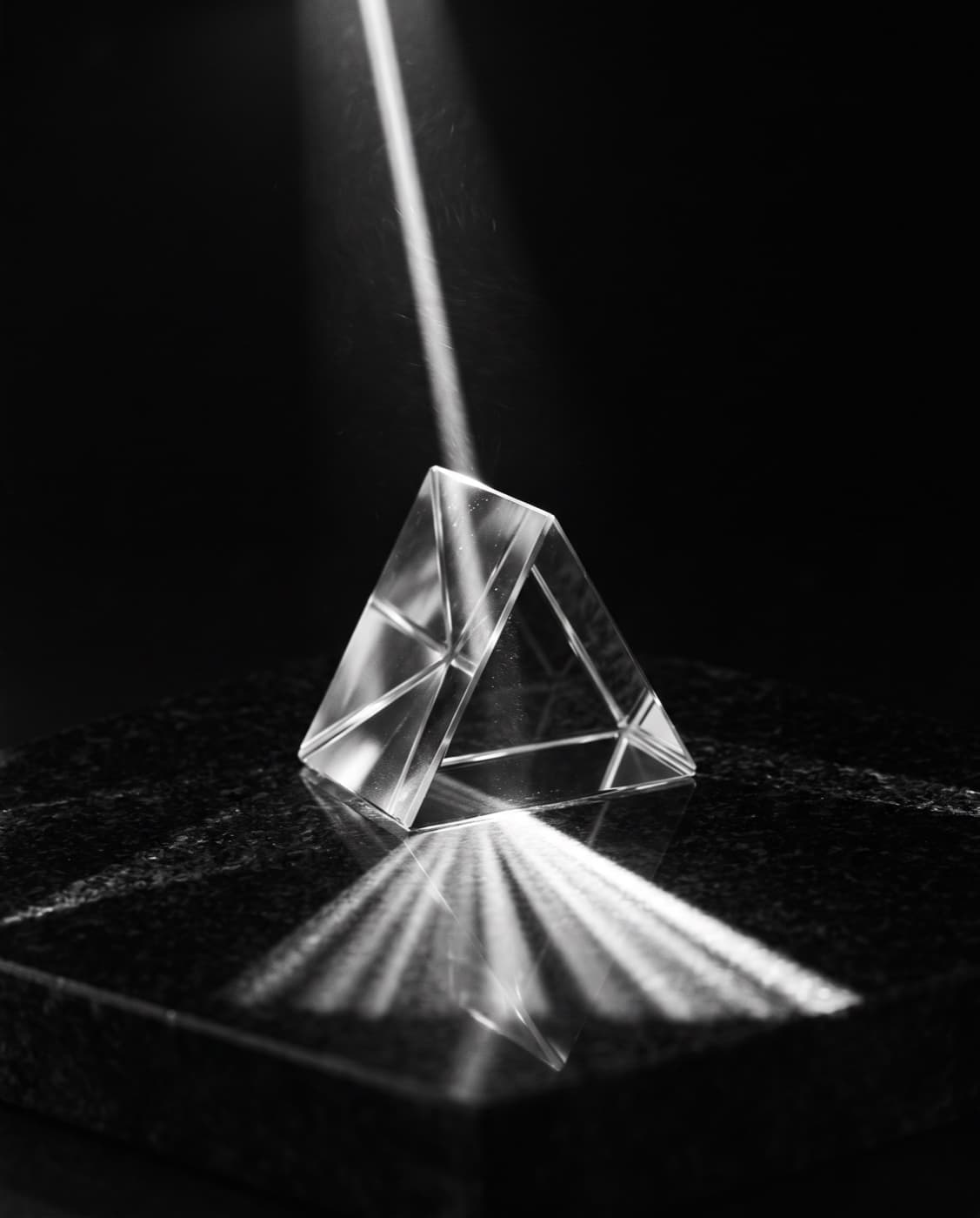 A glass prism refracting a shaft of light